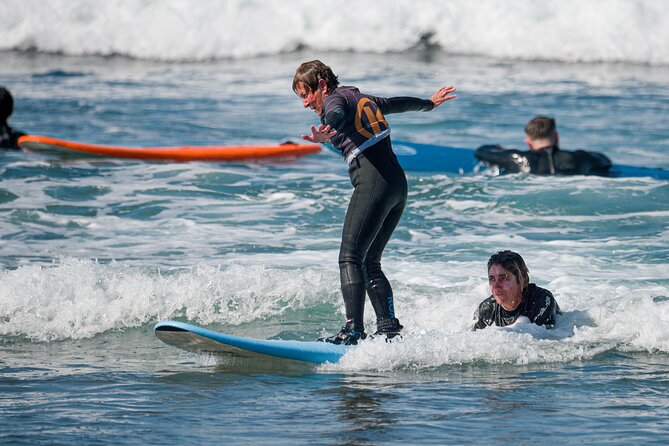 small group surf lesson in Playa de las Américas,Tenerife - Learning to Stand: The Instructor’s Job Is to Keep You Trying